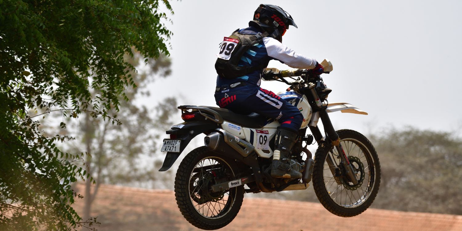 Rider #09 on a Hero Xpulse 200 catches air over a dusty crest during the Trail Attack 8 race.
