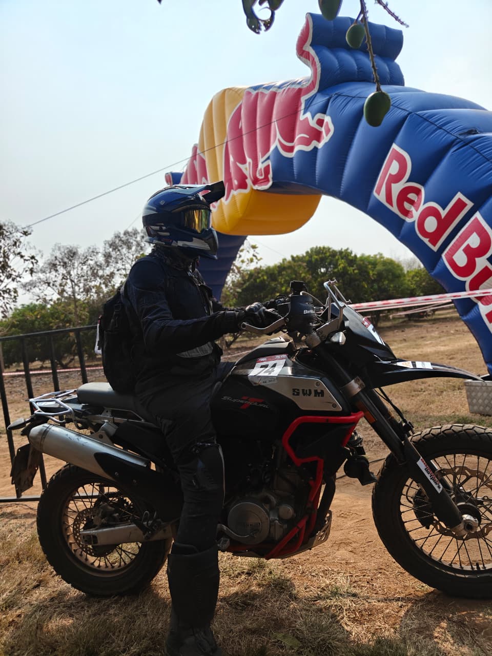 A group of riders at the starting line of the BigRock Dirt Park Trail Attack 8 track, surrounded by trees.